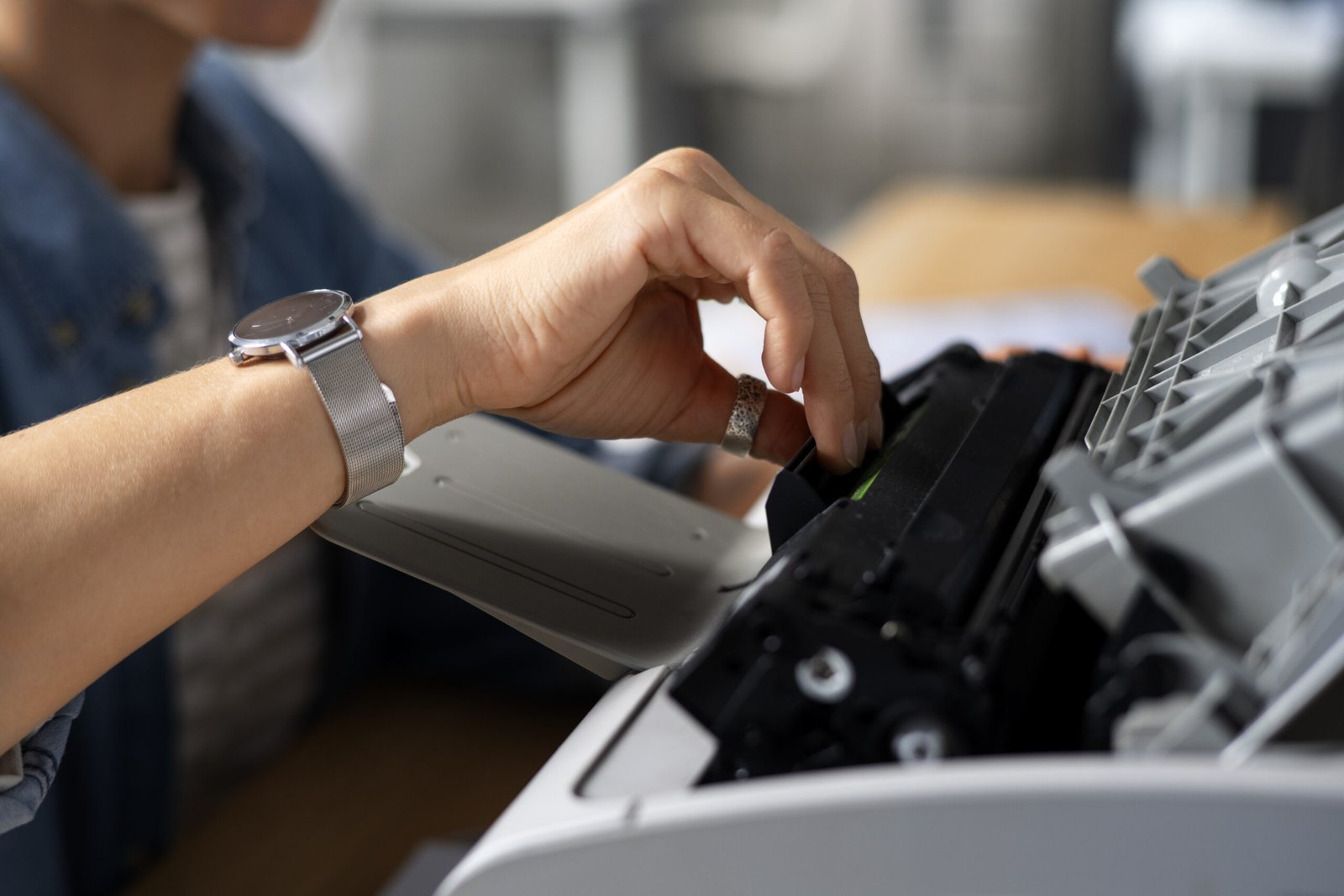 Worker testing and inspecting a refurbished printer